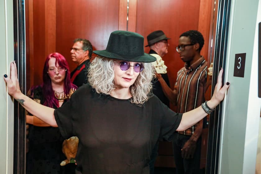 Sheri and the cast in an elevator