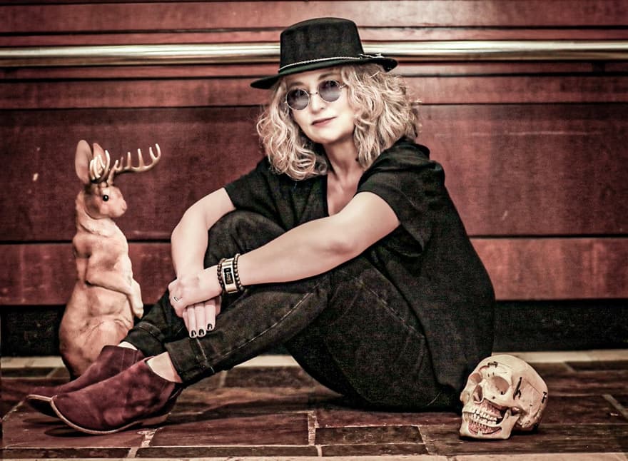 Sheri Lynch, seated, with a jackalope and a skull